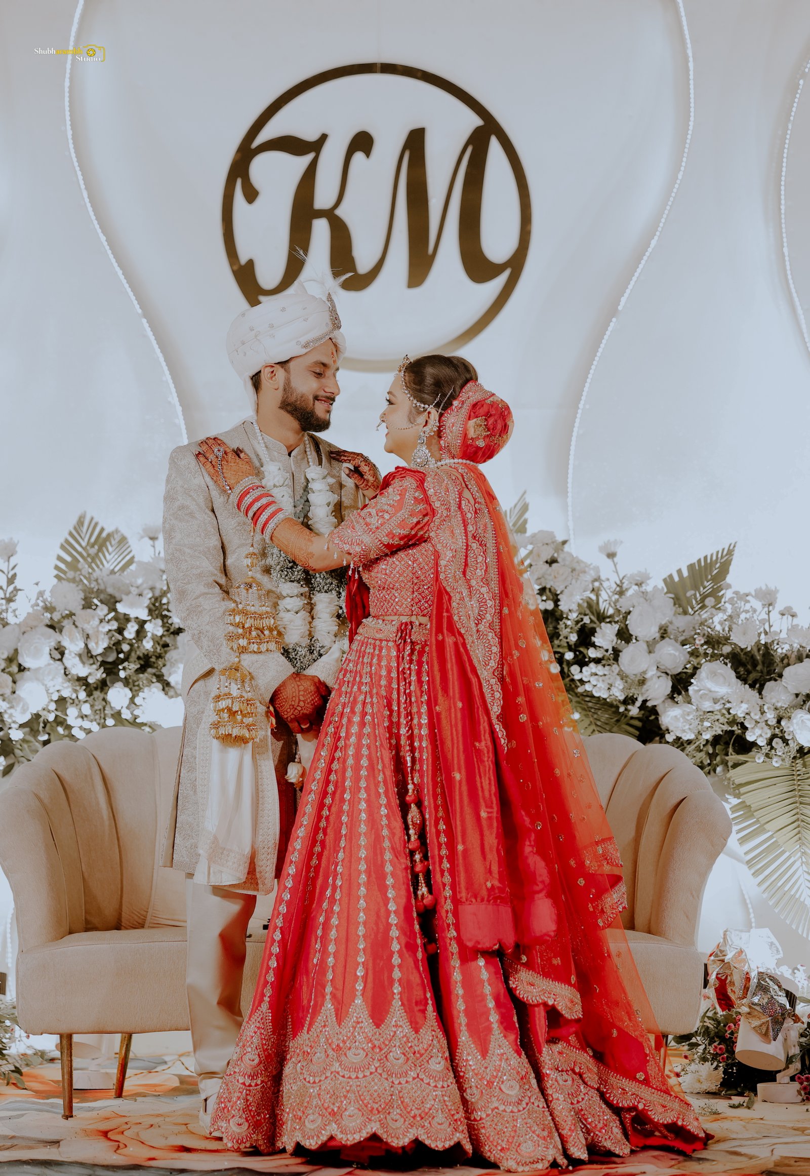Bride in red lehenga twirling beside a lit pool at night